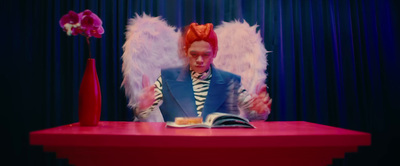 a man sitting at a table reading a book