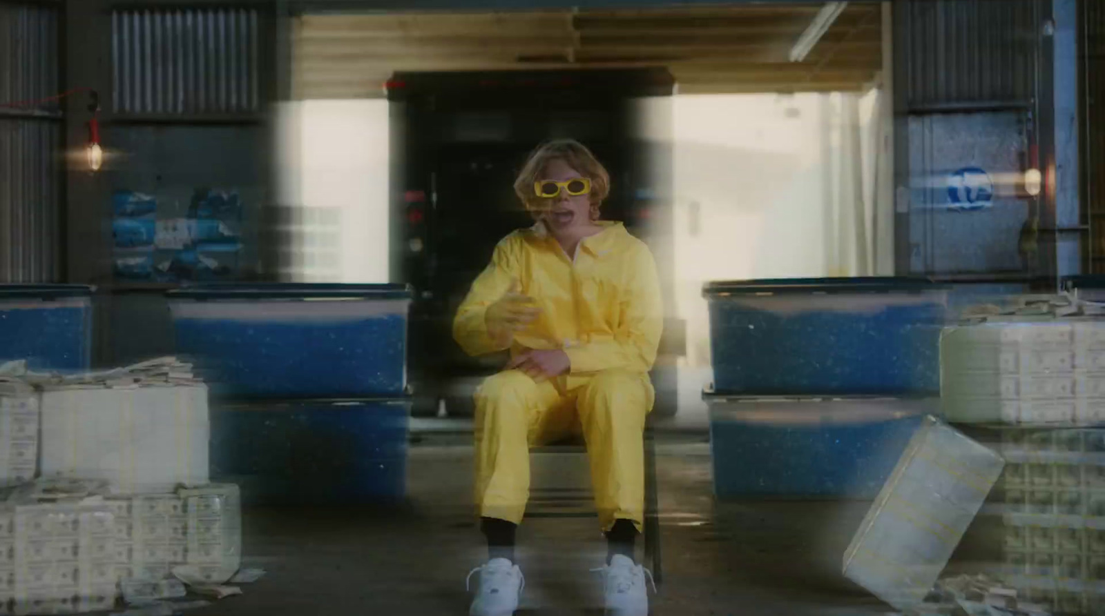 a man in a yellow suit sitting on a chair