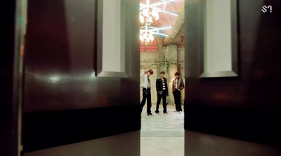 a group of men standing next to each other in a hallway