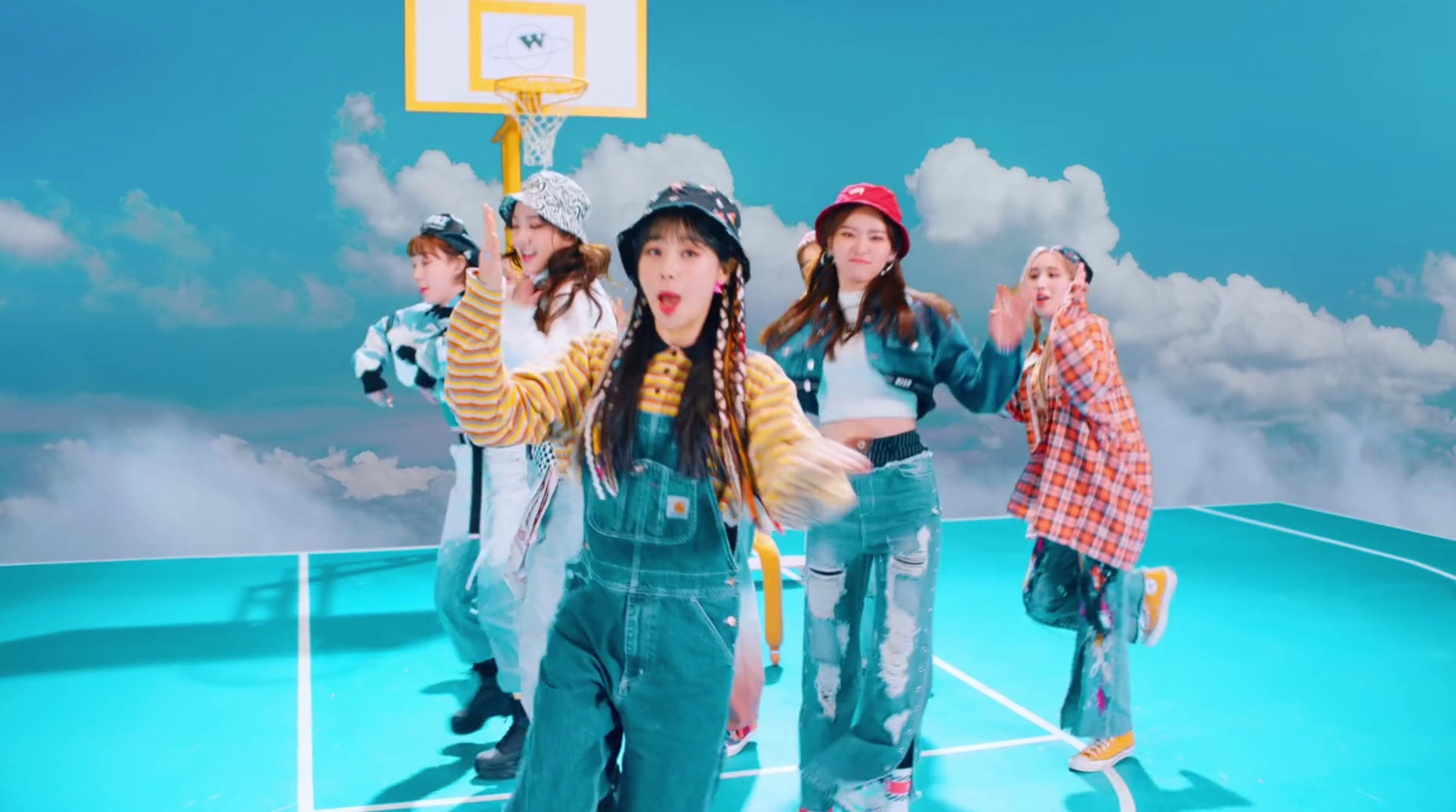 a group of young women standing on top of a basketball court