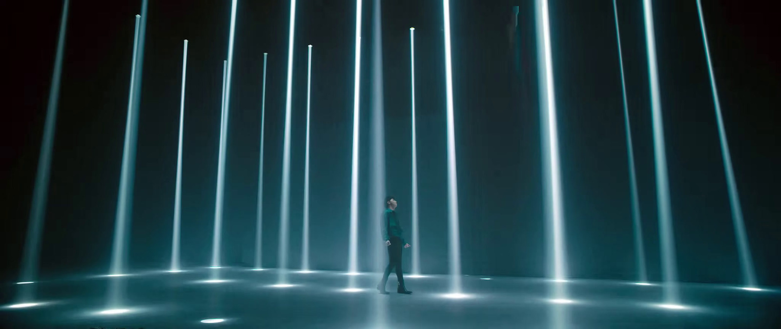 a person standing in front of a wall of lights