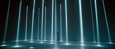 a person standing in front of a wall of lights