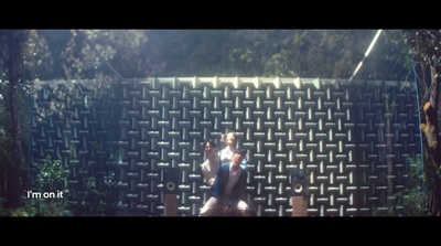 a man sitting on a bench in front of a wall