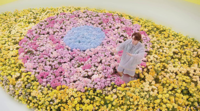 a woman standing in a field of flowers