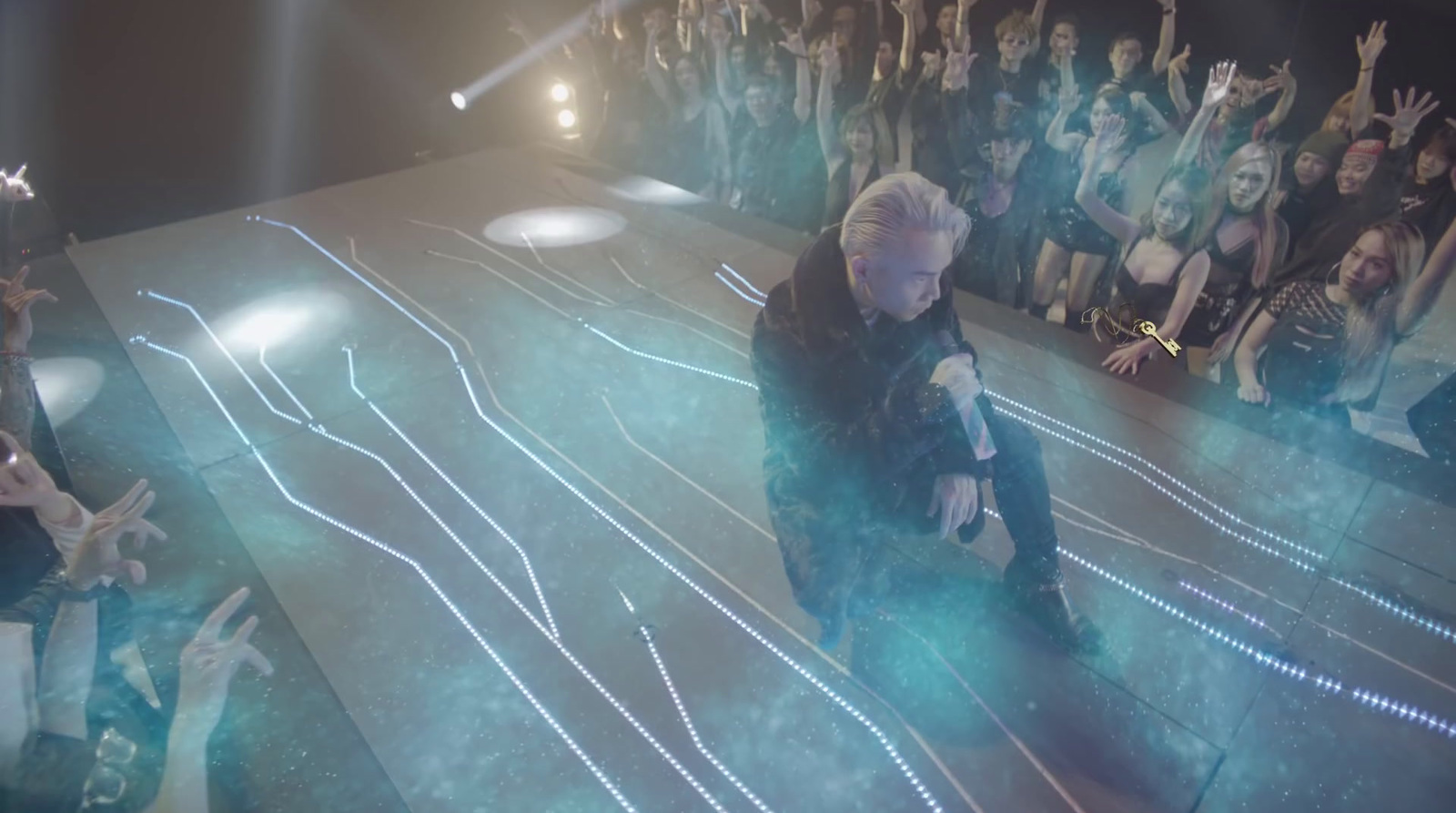 a man standing on top of a stage in front of a crowd