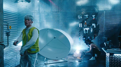 a man standing in front of a satellite dish