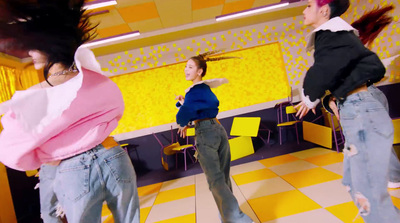 a group of young women standing on top of a checkered floor