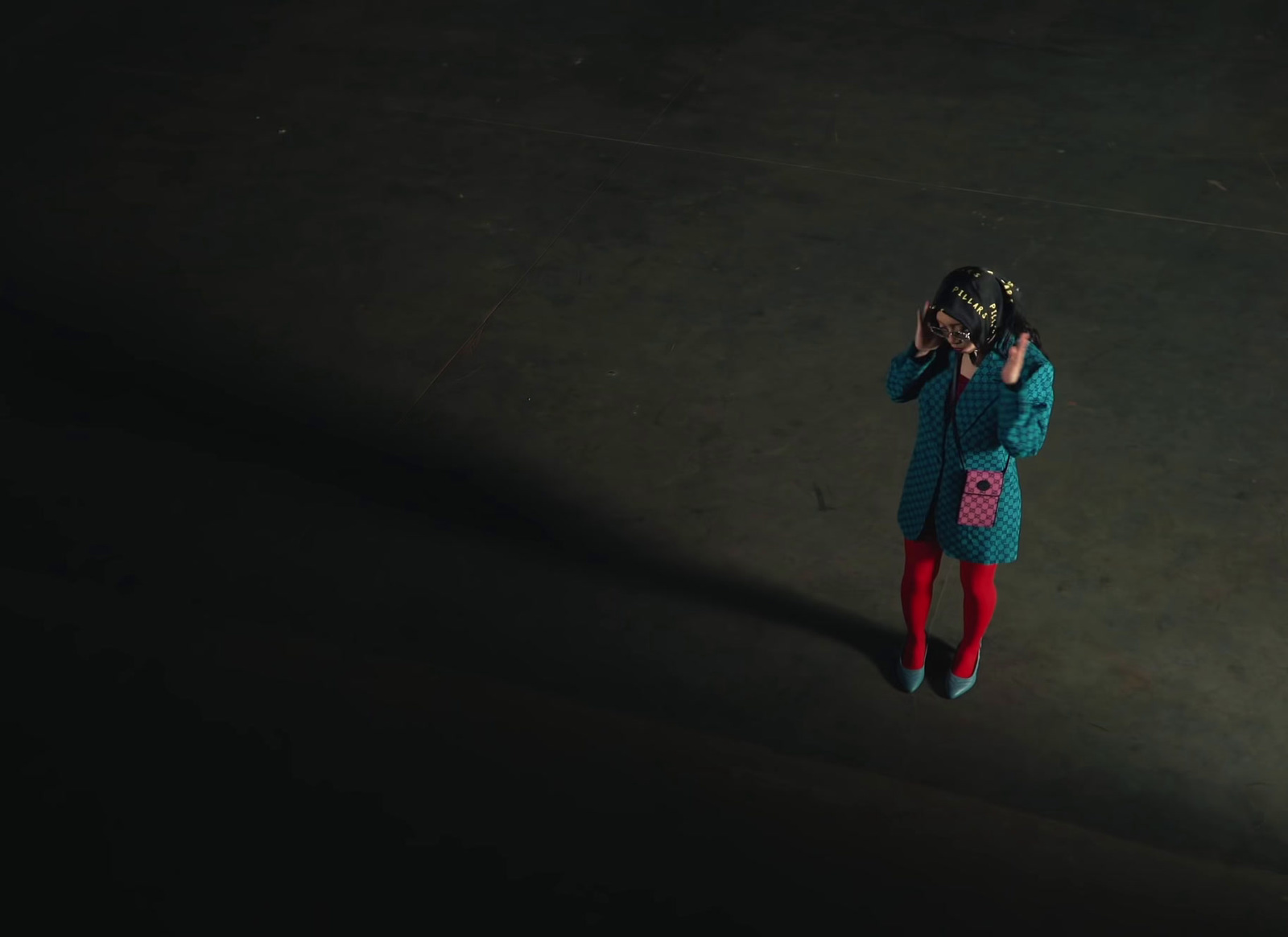 a little girl standing in the dark talking on a cell phone