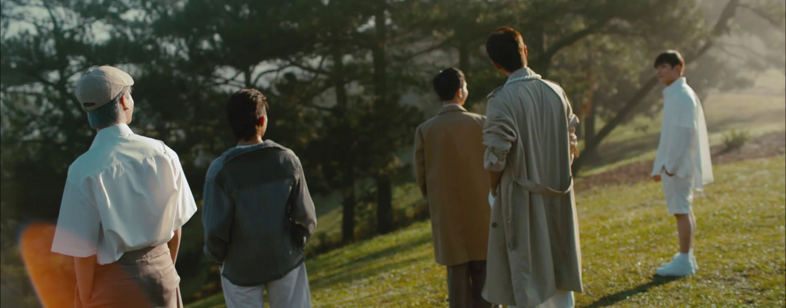 a group of men standing on top of a lush green field