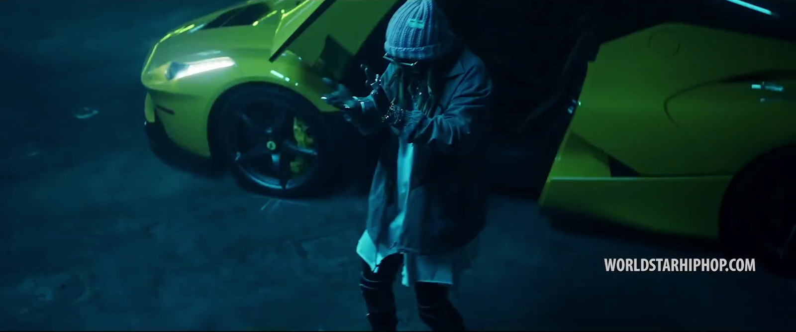 a man standing next to a yellow sports car