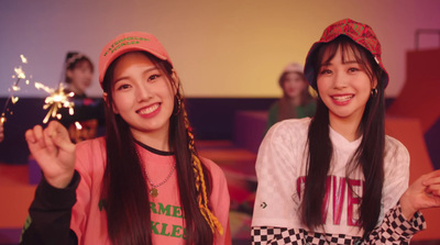 two girls are smiling and holding sparklers