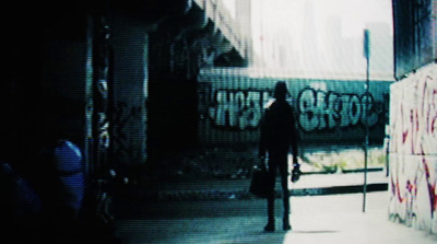 a man standing in front of a wall with graffiti on it