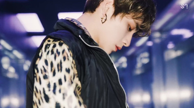 a male in a black jacket and a leopard print jacket