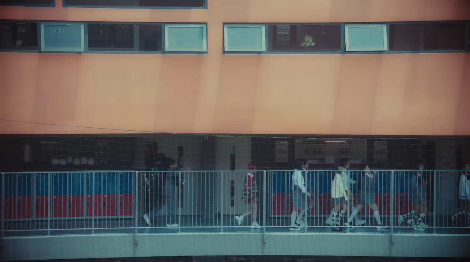 a group of people walking across a bridge