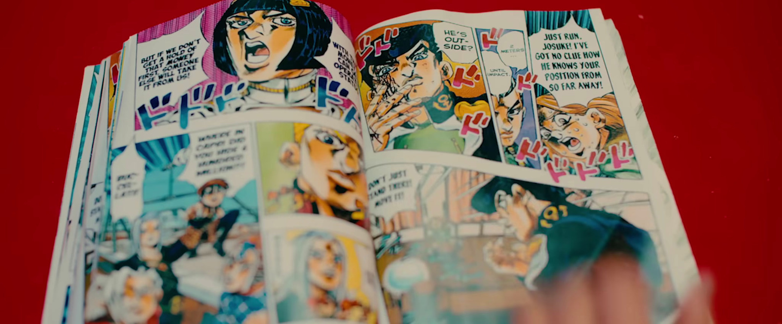 a person holding a book open to a comic