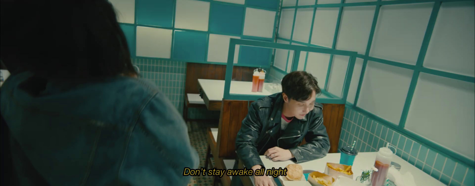 a man sitting at a table in a diner