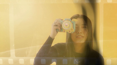 a woman taking a picture of herself with a camera