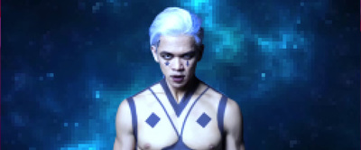 a man with white hair and no shirt standing in front of a blue background