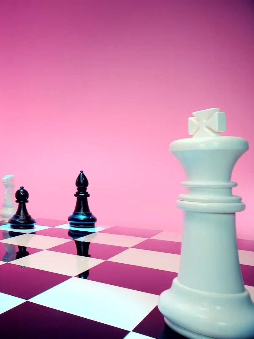 a group of chess pieces sitting on top of a checkered floor