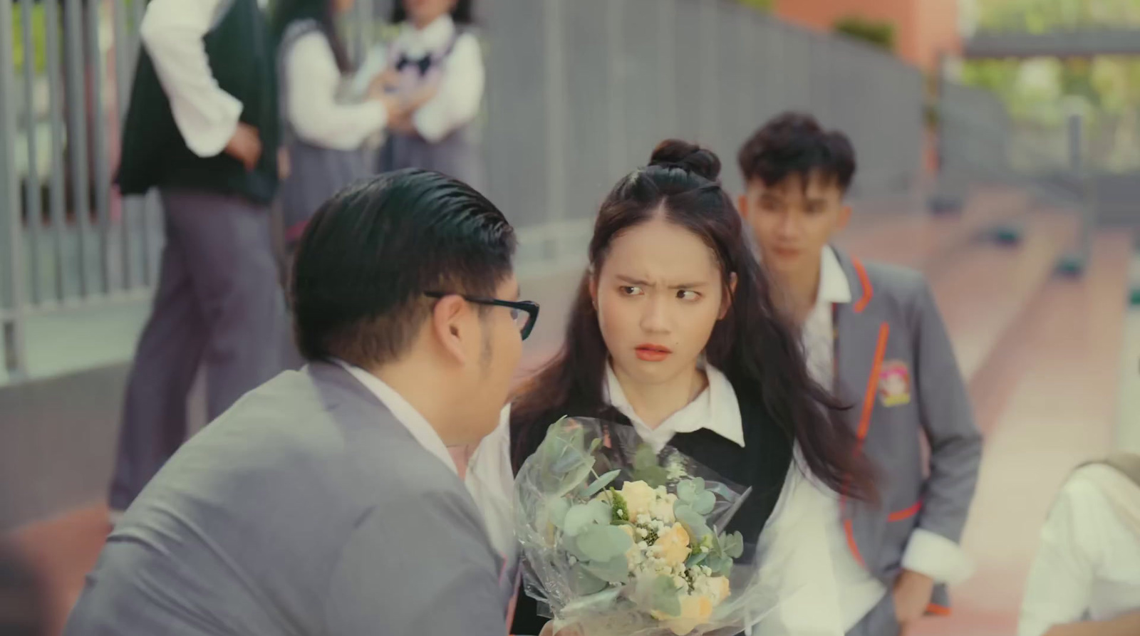 a man holding a bouquet of flowers next to a woman