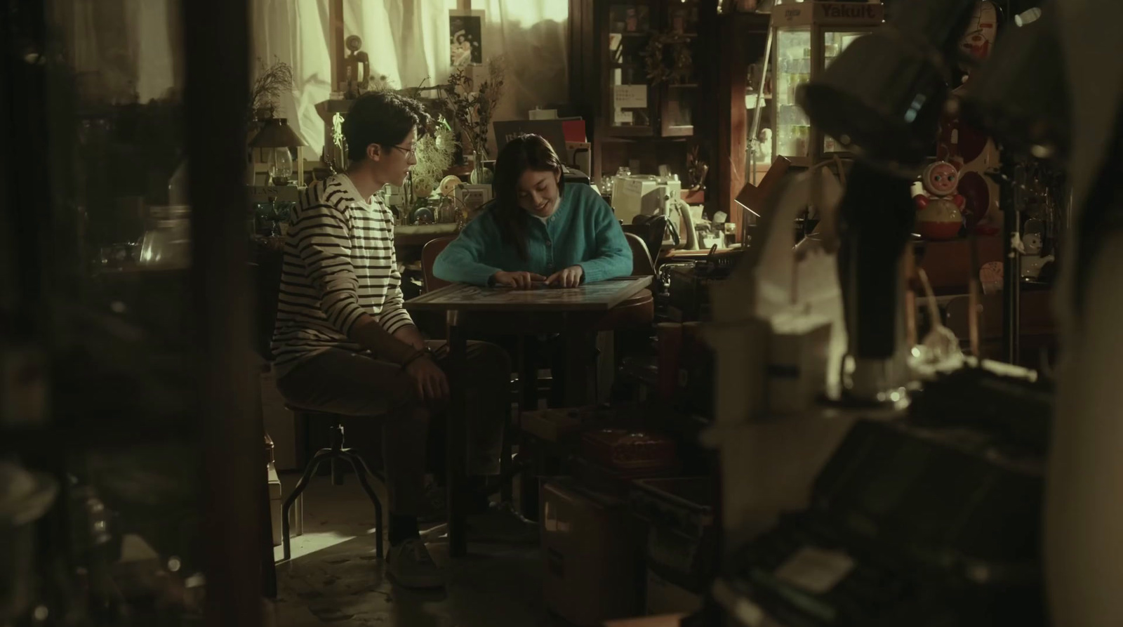 a couple of women sitting at a table in a room