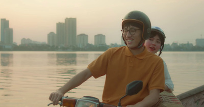 a man riding a motorcycle next to a woman