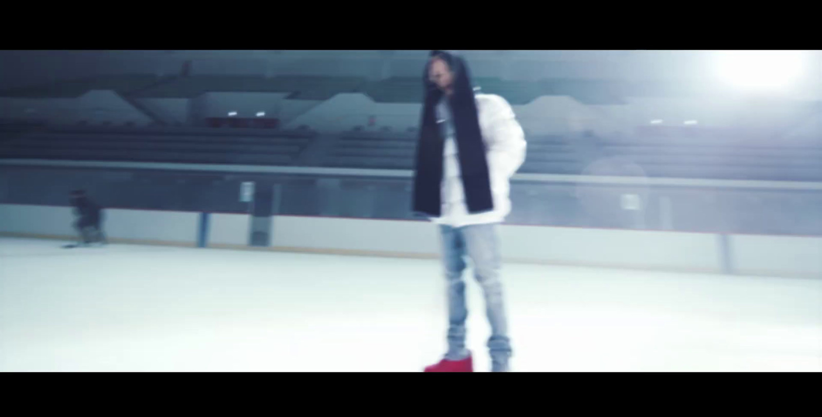 a man standing on top of an ice rink