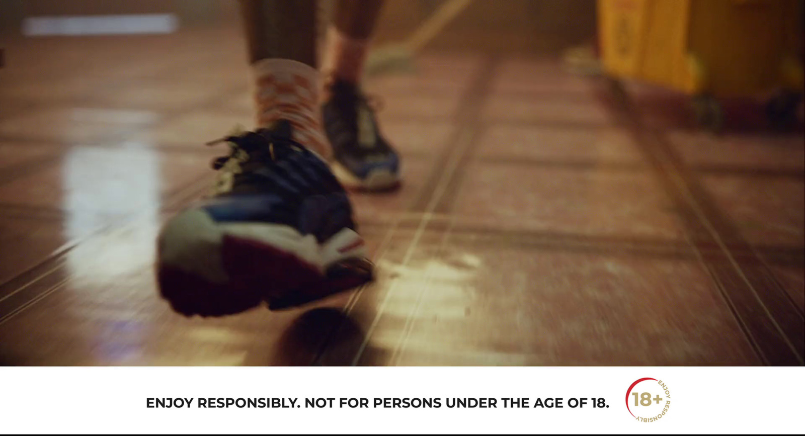 a person is riding a skateboard on a tiled floor