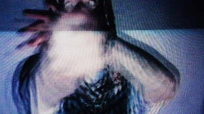 a blurry image of a woman's body on a television screen