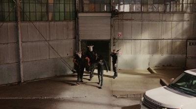 a group of people standing in front of a garage door