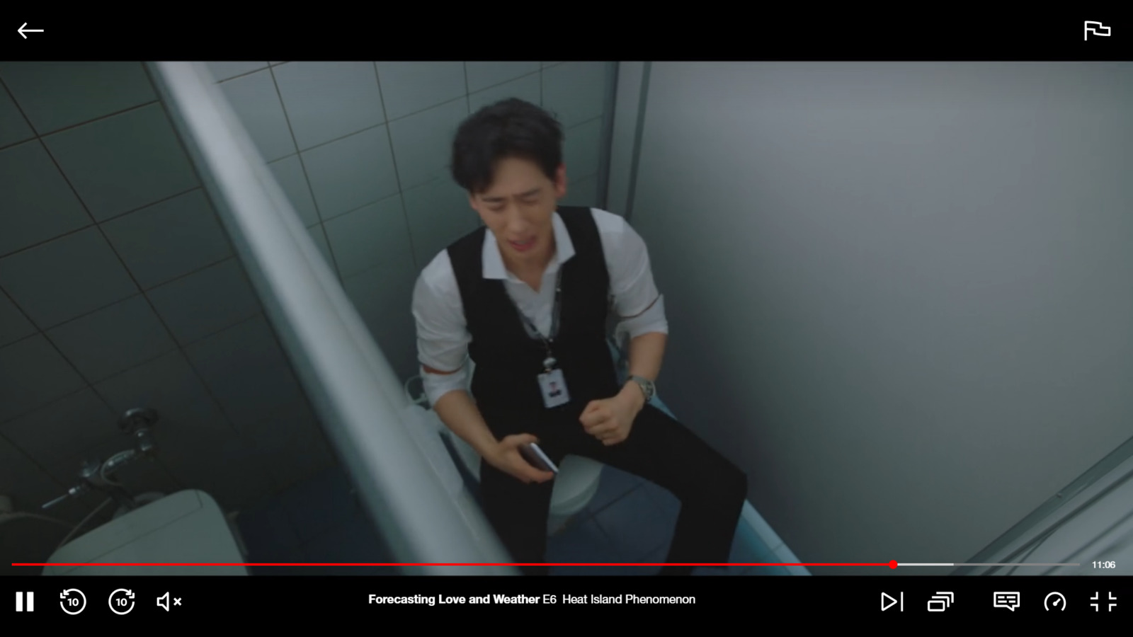 a man sitting on a toilet in a bathroom