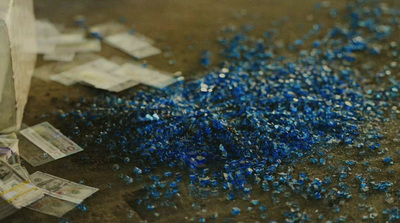 a bunch of blue confetti sitting on top of a table