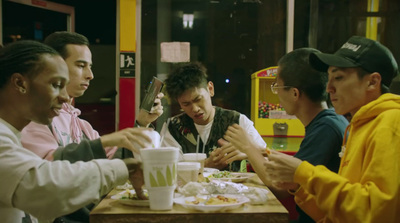 a group of people sitting around a table eating food