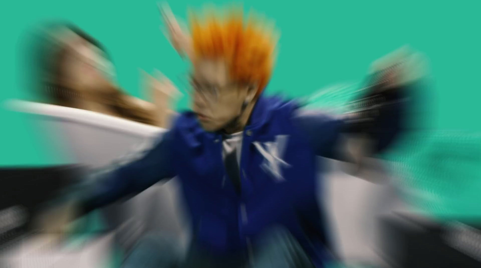 a blurry image of a man with orange hair