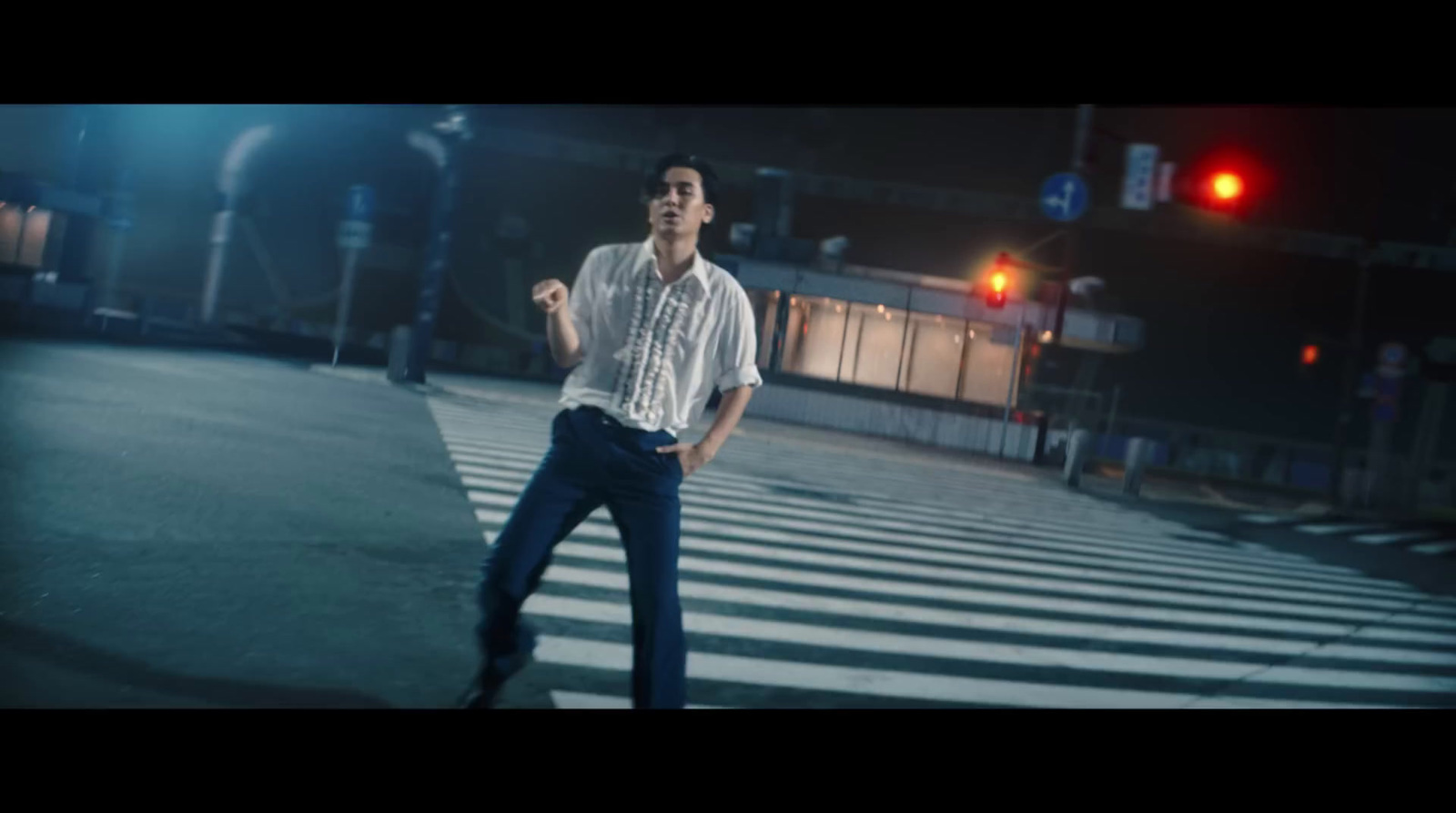 a man standing in the middle of a cross walk