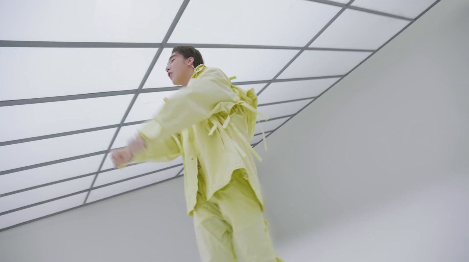 a man in a yellow outfit standing in a room