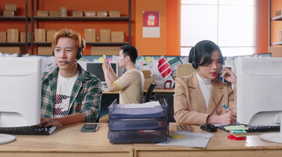 a couple of people sitting at a desk with computers