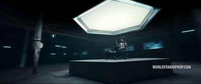 a man sitting on top of a table in a dark room