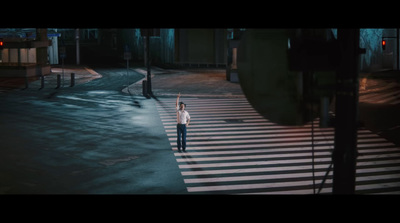 a person standing in the middle of a cross walk