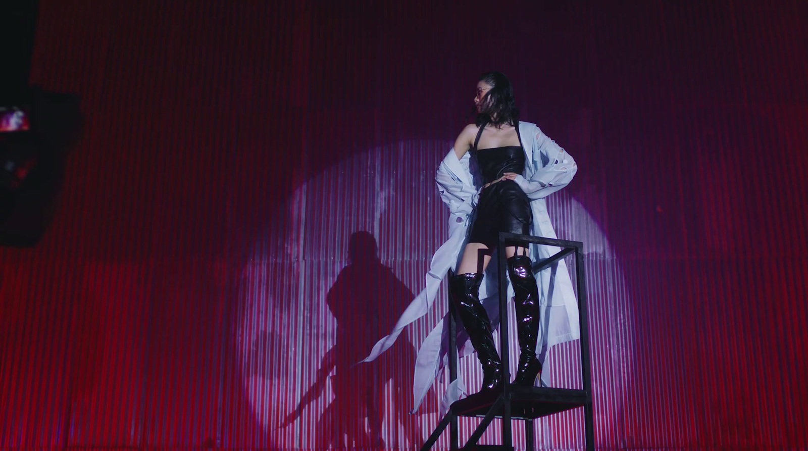 a woman standing on top of a chair on a stage