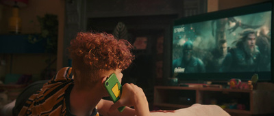 a woman with red hair sitting in front of a tv