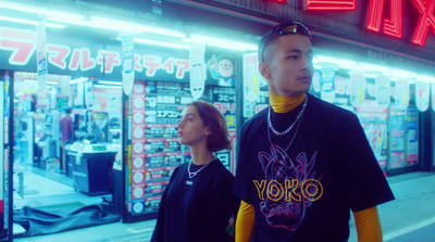 a man and a woman standing in front of a store