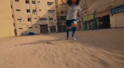 a woman in a white shirt is skateboarding down a street