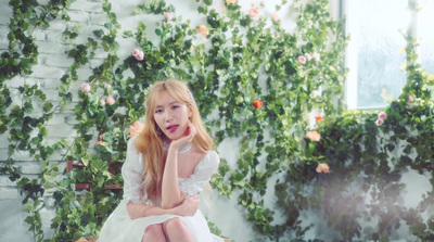 a woman in a white dress sitting on a bench