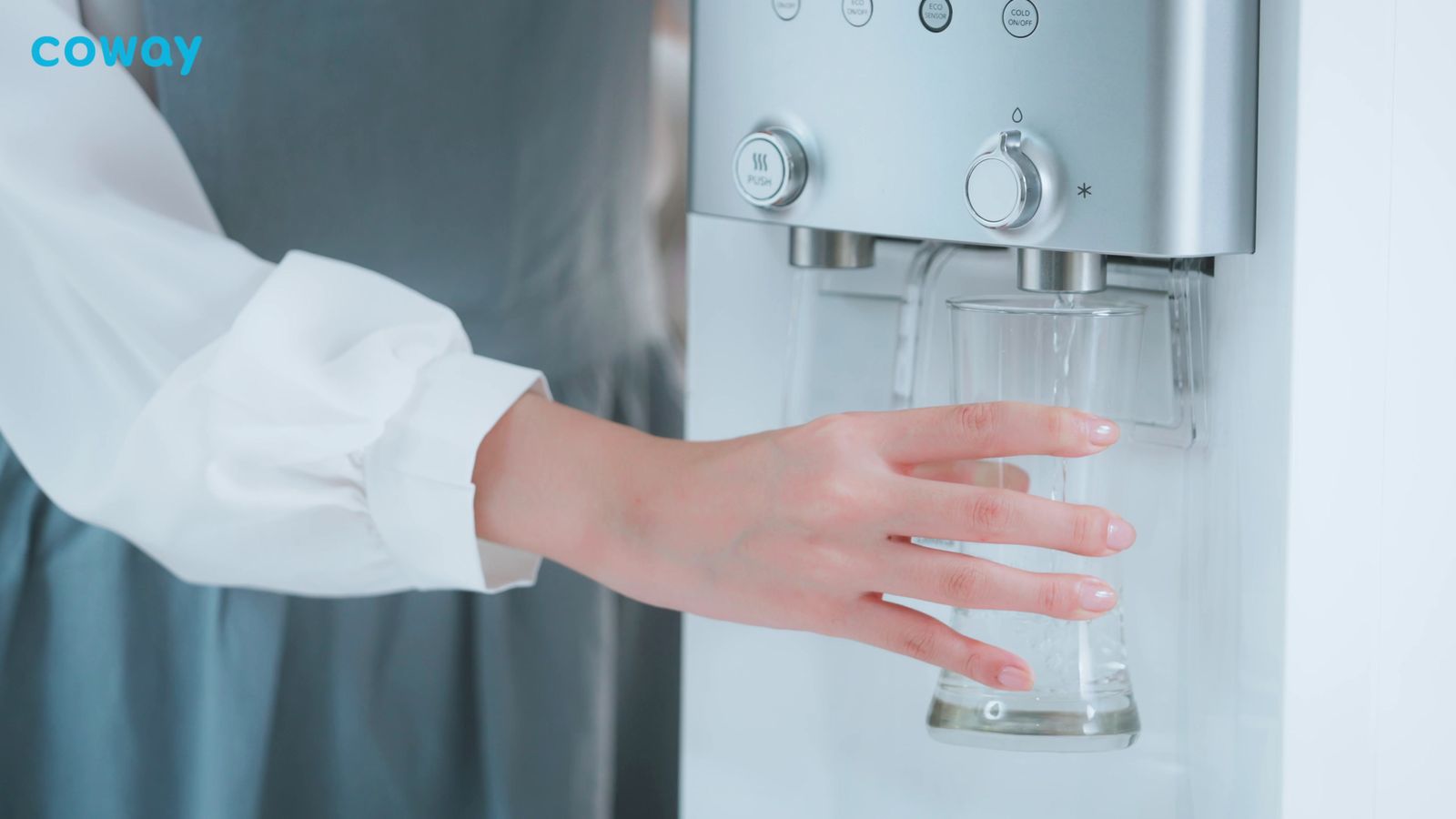 a woman is holding a glass in her hand