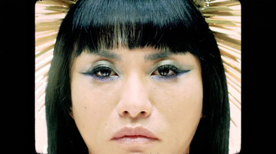 a close up of a person wearing a head piece