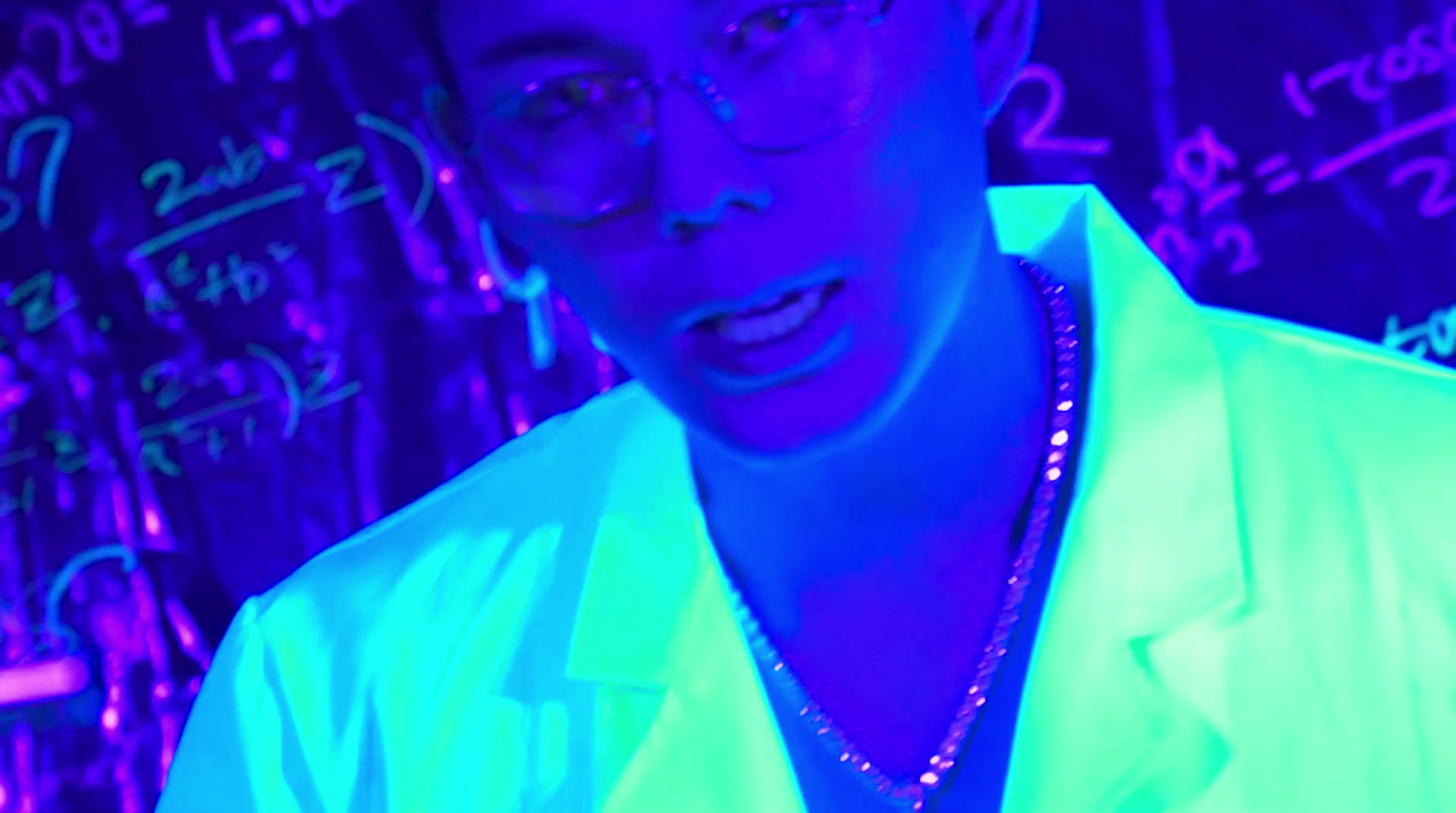 a man wearing glasses and a neon shirt