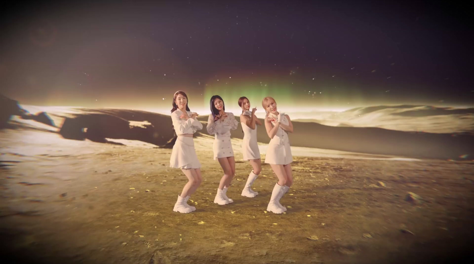 a group of women standing on top of a dirt field