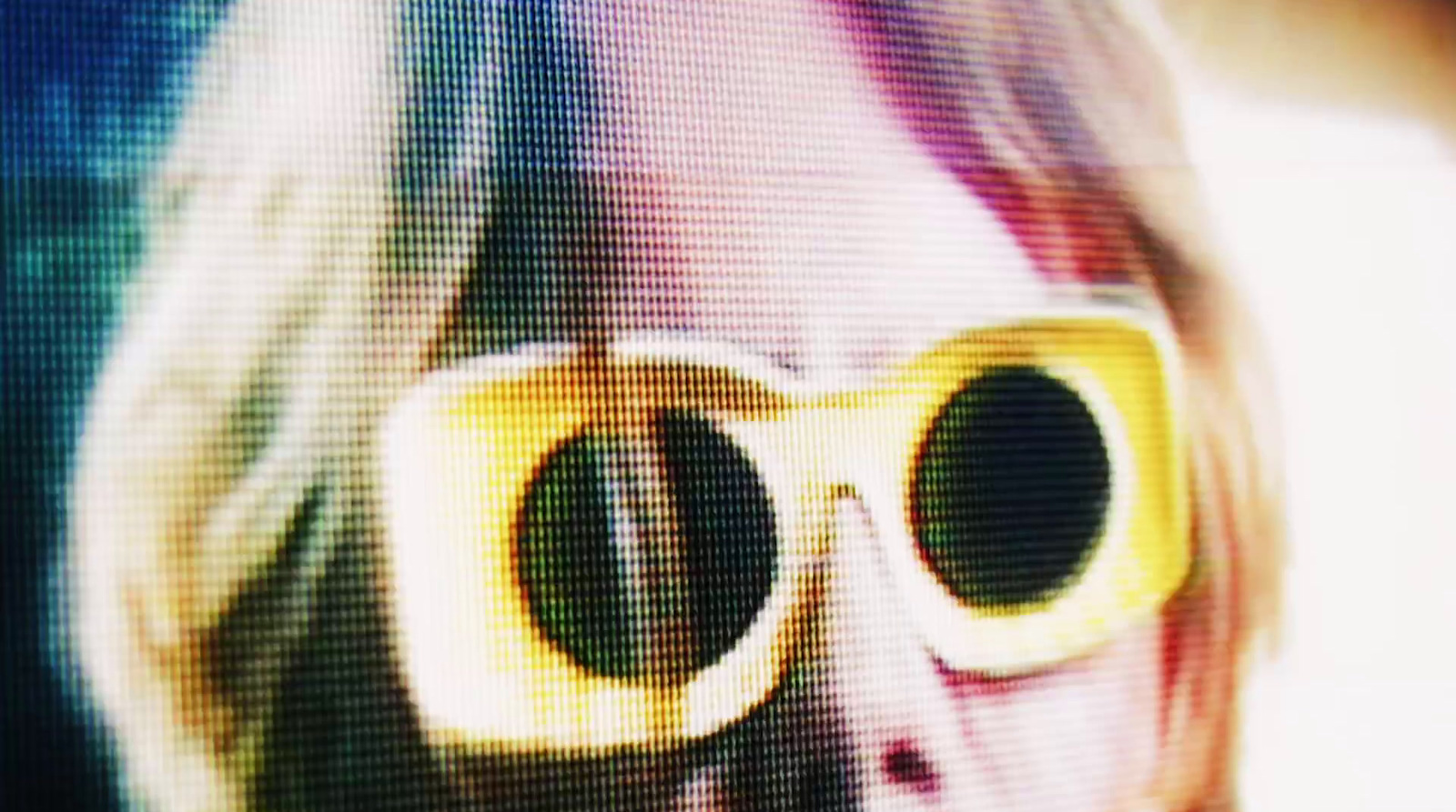 a close up of a person wearing yellow glasses