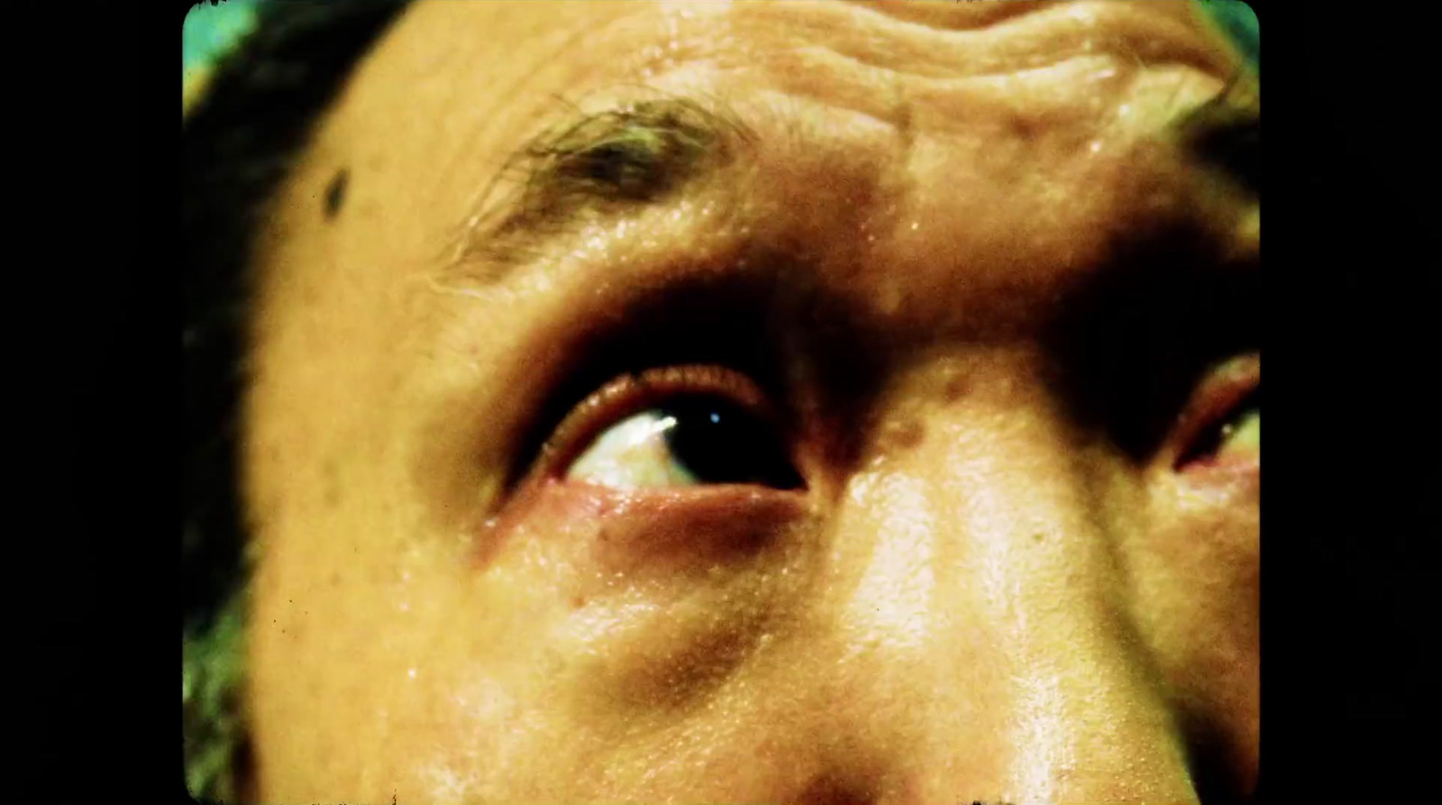 a close up of a man's eye with a black background